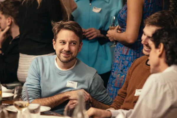 Márton Csernai in conversation at a startup fundraiser dinner event